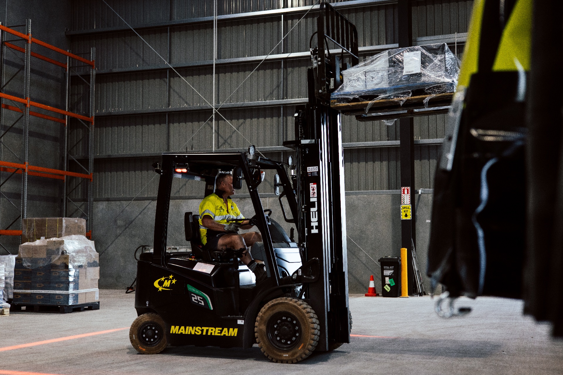 Picture of a Mainstream employee driving an Electric Forklift